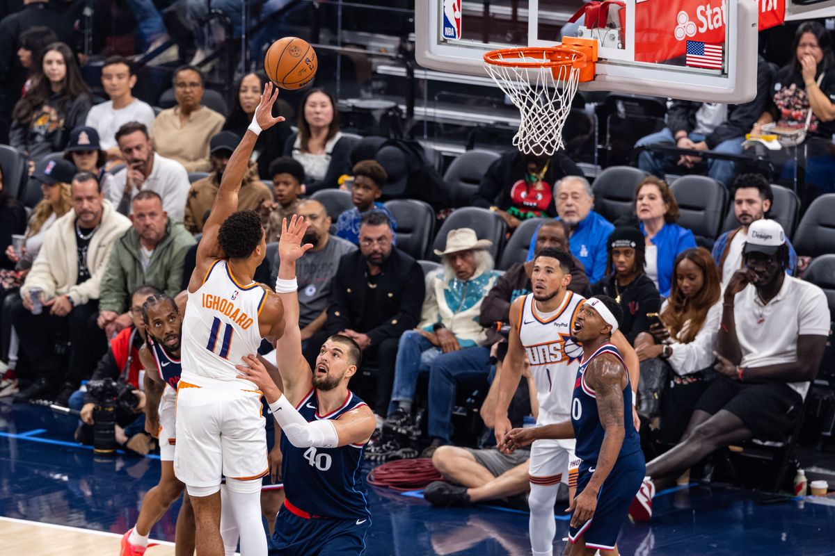 Forward Oso Ighodaro #11 of the Phoenix Suns shoots a hook shot over center Ivica Zubac #40 of the LA Clippers during an NBA game at the Intuit Dome on October 24, 2025 in Inglewood California.