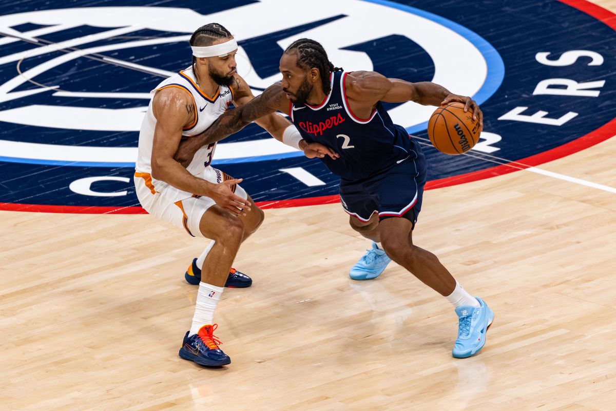 Forward Kawhi Leonard #2 of the LA Clippers handles the ball against forward Dillon Brooks #3 of the Phoenix Suns during an NBA game at the Intuit Dome on October 24, 2025 in Inglewood California.
