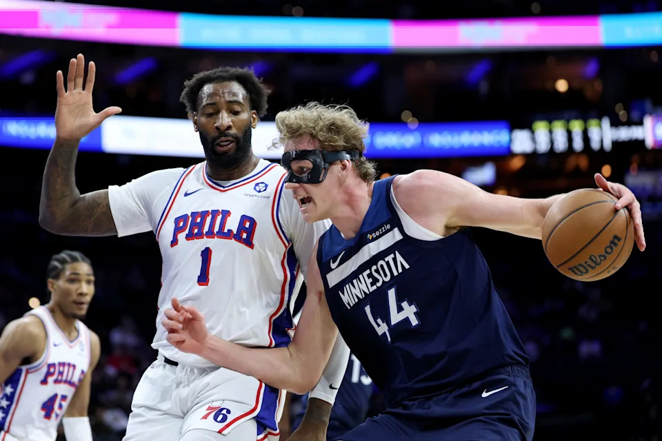 PHILADELPHIA, PENNSYLVANIA - OCTOBER 17: Rocco Zikarsky #44 of the Minnesota Timberwolves drives against Andre Drummond #1 of the Philadelphia 76ers during the second half at Xfinity Mobile Arena on October 17, 2025 in Philadelphia, Pennsylvania. NOTE TO USER: User expressly acknowledges and agrees that, by downloading and or using this photograph, User is consenting to the terms and conditions of the Getty Images License Agreement. (Photo by Emilee Chinn/Getty Images)