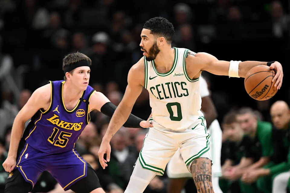 Mar 8, 2025; Boston, Massachusetts, USA; Boston Celtics forward Jayson Tatum (0) dribbles the ball against Los Angeles Lakers guard Austin Reaves (15) during the second quarter at the TD Garden. Mandatory Credit: Brian Fluharty-Imagn Images
