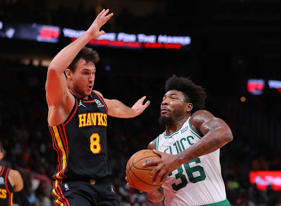 ATLANTA, GEORGIA - NOVEMBER 17: Marcus Smart #36 of the Boston Celtics drives against Danilo Gallinari #8 of the Atlanta Hawks during the second half at State Farm Arena on November 17, 2021 in Atlanta, Georgia. NOTE TO USER: User expressly acknowledges and agrees that, by downloading and or using this photograph, User is consenting to the terms and conditions of the Getty Images License Agreement. (Photo by Kevin C. Cox/Getty Images)