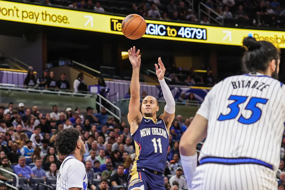 Oct 16, 2025; Orlando, Florida, USA; New Orleans Pelicans guard Bryce McGowens (11) shoots over Orlando Magic guard Jase Richardson (11) during the second half at Kia Center.