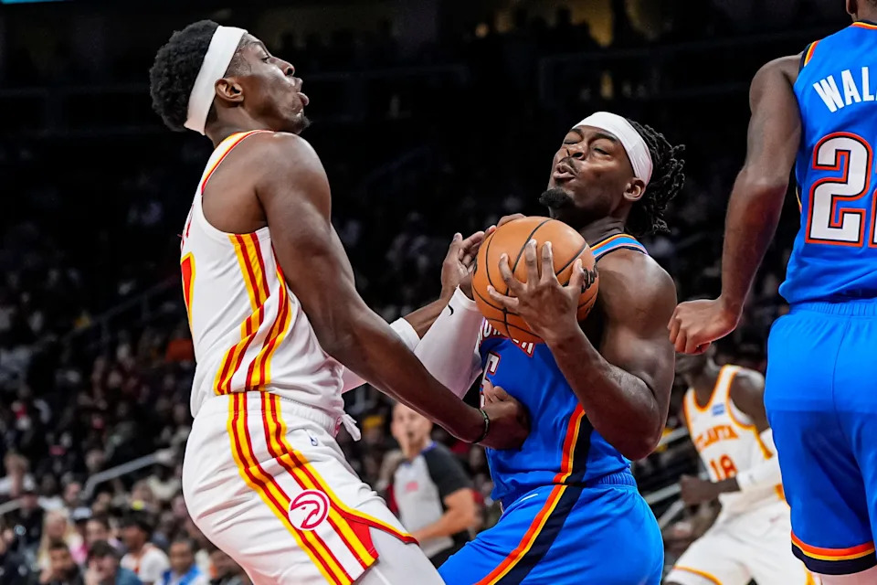 Oct 25, 2025; Atlanta, Georgia, USA; Atlanta Hawks forward Onyeka Okongwu (17) and Oklahoma City Thunder guard Luguentz Dort (5) fight for the ball during the first half at State Farm Arena. Mandatory Credit: Dale Zanine-Imagn Images