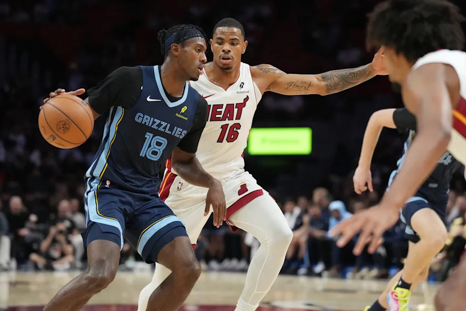 Oct 17, 2025; Miami, Florida, USA; Memphis Grizzlies forward Olivier-Maxence Prosper (18) drives to the basket as Miami Heat forward Keshad Johnson (16) defends during the second half at Kaseya Center.