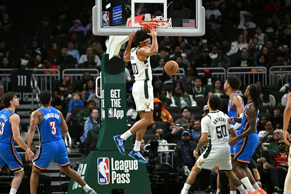 Oct 14, 2025; Milwaukee, Wisconsin, USA; Milwaukee Bucks center Jericho Sims (00) dunks against the Oklahoma City Thunder during the second half at Fiserv Forum.