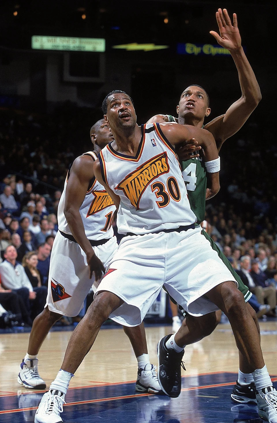 18 Feb 2000: Billy Owens #30 of the Golden State Warriors guards Tony Battie #4 of the Boston Celtics at the Oakland Coliseum in Oakland, California. The Warriors defeated the Celtics 122-100. Mandatory Credit: Jed Jacobsohn /Allsport