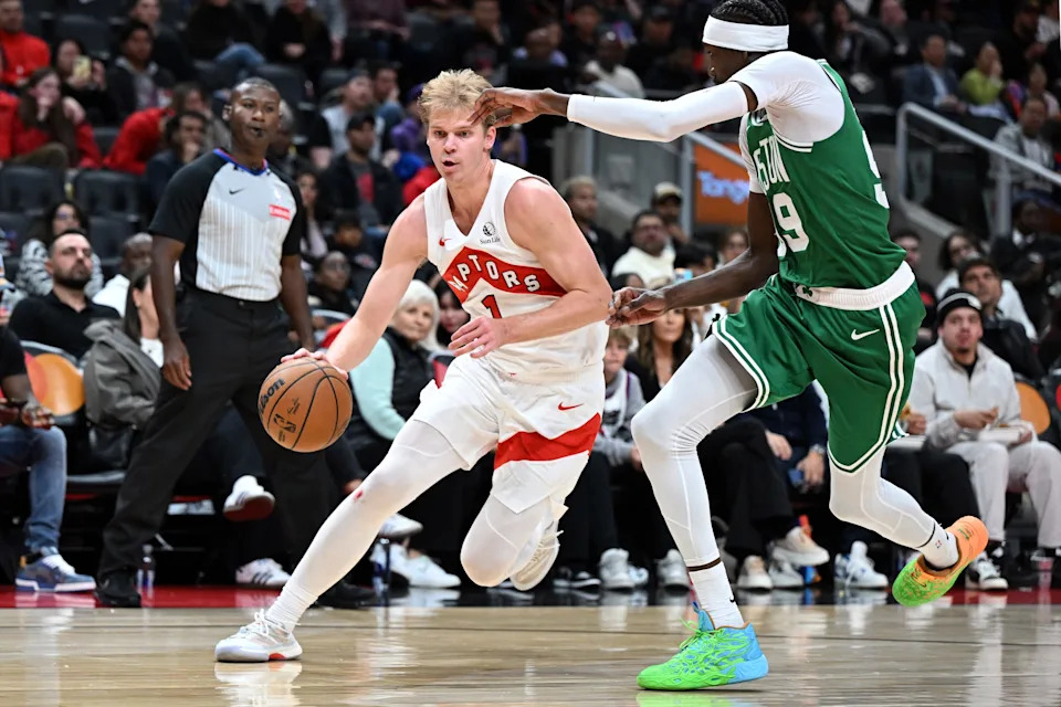 Oct 10, 2025; Toronto, Ontario, CAN; Toronto Raptors forward Gradey Dick (1) dribbles the ball past Boston Celtics forward Chris Boucher (99) in the second half at Scotiabank Arena. Mandatory Credit: Dan Hamilton-Imagn Images
