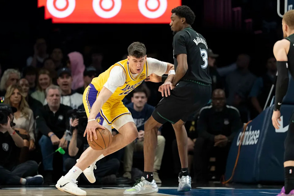 Los Angeles Lakers forward Jake LaRavia (12) dribbles towards the basket as Minnesota Timberwolves forward Jaden McDaniels (3).