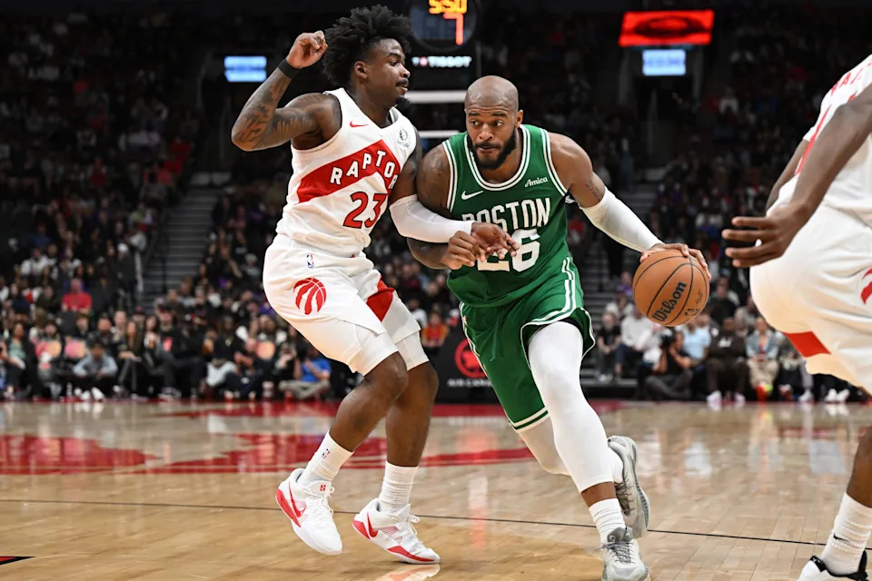 Oct 10, 2025; Toronto, Ontario, CAN; Boston Celtics forward Xavier Tillman Sr. (26) dribbles the ball as Toronto Raptors guard Jamal Shead (23) defends in the first half at Scotiabank Arena. Mandatory Credit: Dan Hamilton-Imagn Images