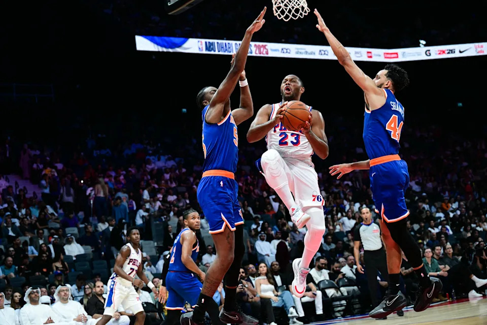 Philadelphia 76ers' #23 Eric Gordon takes a shot past New York Knicks' #44 Landry Shamet and New York Knicks' #55 Ariel Hukporti during the NBA basketball game between the New York Knicks and the Philadelphia 76ers at the Etihad Arena in Abu Dhabi on October 2, 2025. (Photo by Giuseppe CACACE / AFP) (Photo by GIUSEPPE CACACE/AFP via Getty Images)