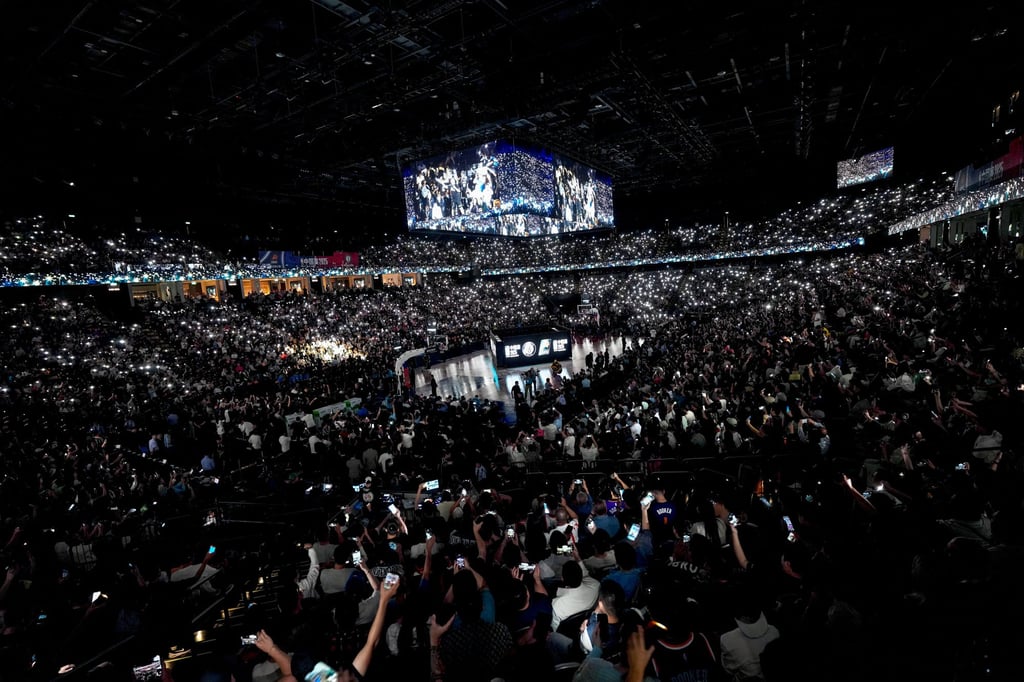 Fans hold up their phones during a break in play at The Venetian Arena. Photo: Karma Lo