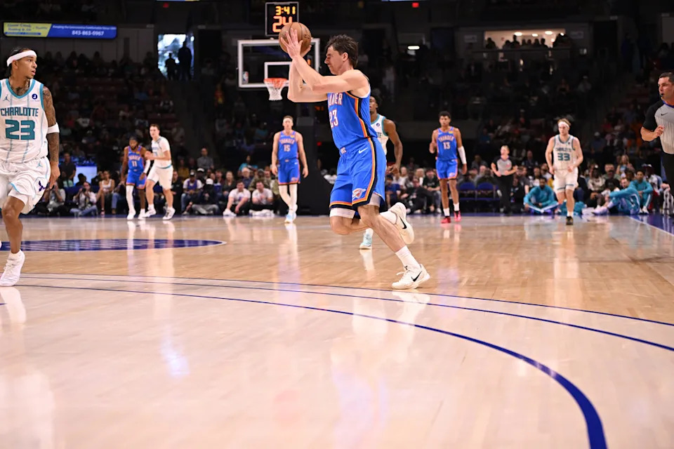 Oct 5, 2025; North Charleston, South Carolina, USA; Oklahoma City Thunder guard Brooks Barnhizer (23) passes off at the top of the key against the Charlotte Hornets in the first quarter at North Charleston Coliseum. Mandatory Credit: Arthur Ellis-Imagn Images