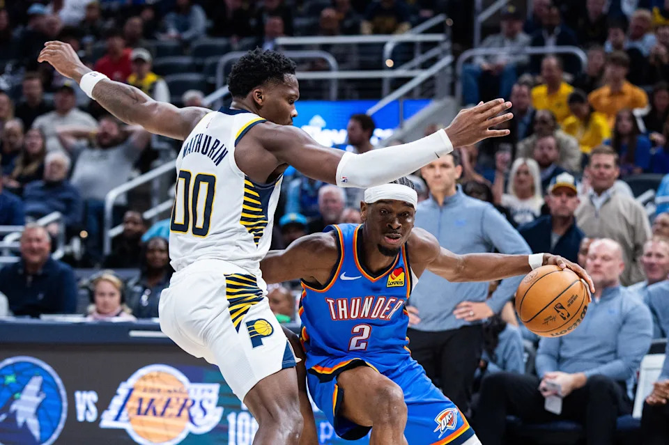 Oct 23, 2025; Indianapolis, Indiana, USA; Oklahoma City Thunder guard Shai Gilgeous-Alexander (2) dribbles the ball while Indiana Pacers guard Bennedict Mathurin (00) defends in the second half at Gainbridge Fieldhouse. Mandatory Credit: Trevor Ruszkowski-Imagn Images