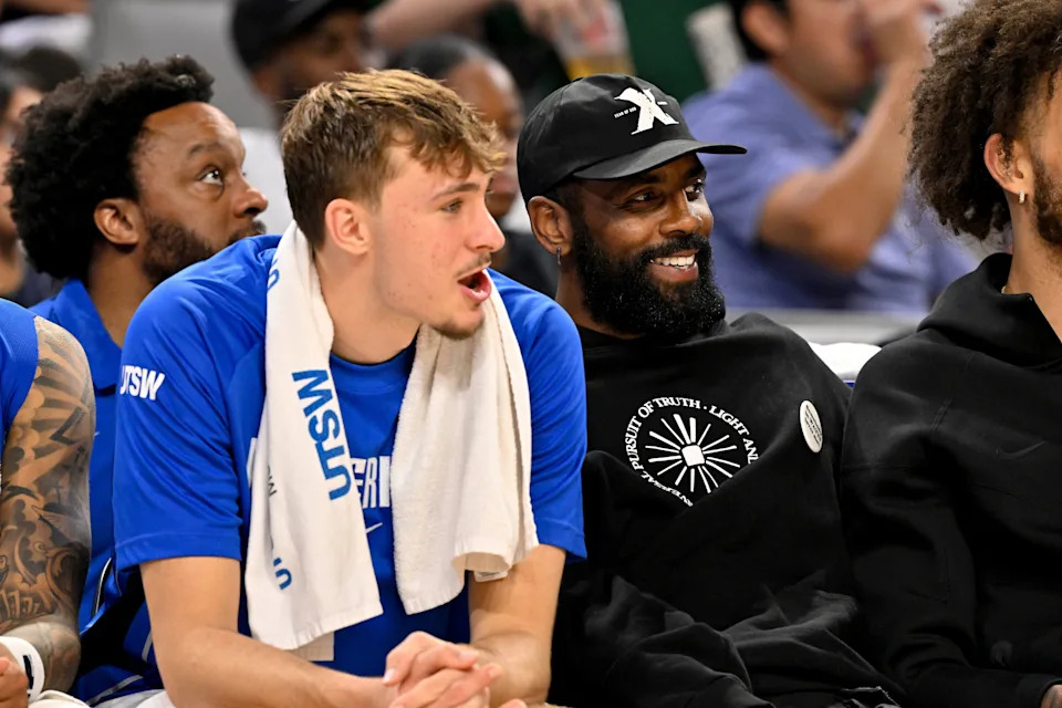 Oct 6, 2025; Fort Worth, Texas, USA; Dallas Mavericks forward Cooper Flagg (left) and guard Kyrie Irving (right) watch the game against the Oklahoma City Thunder during the second half at Dickie's Arena. Mandatory Credit: Jerome Miron-Imagn Images