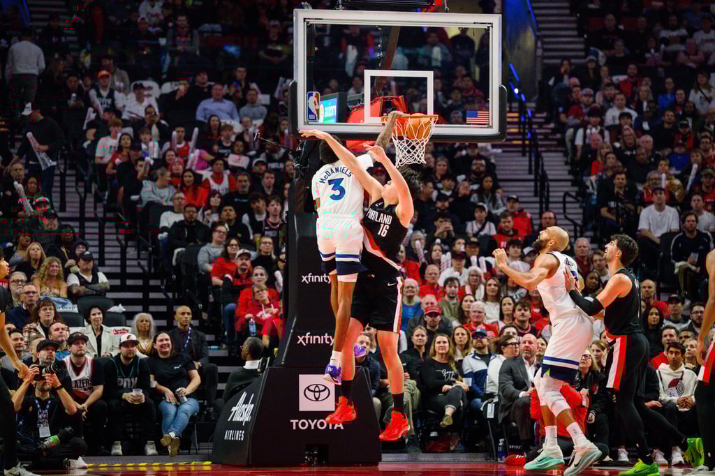 Minnesota Timberwolves forward Jaden McDaniels dunks over Yang Hansen. Photo: AP