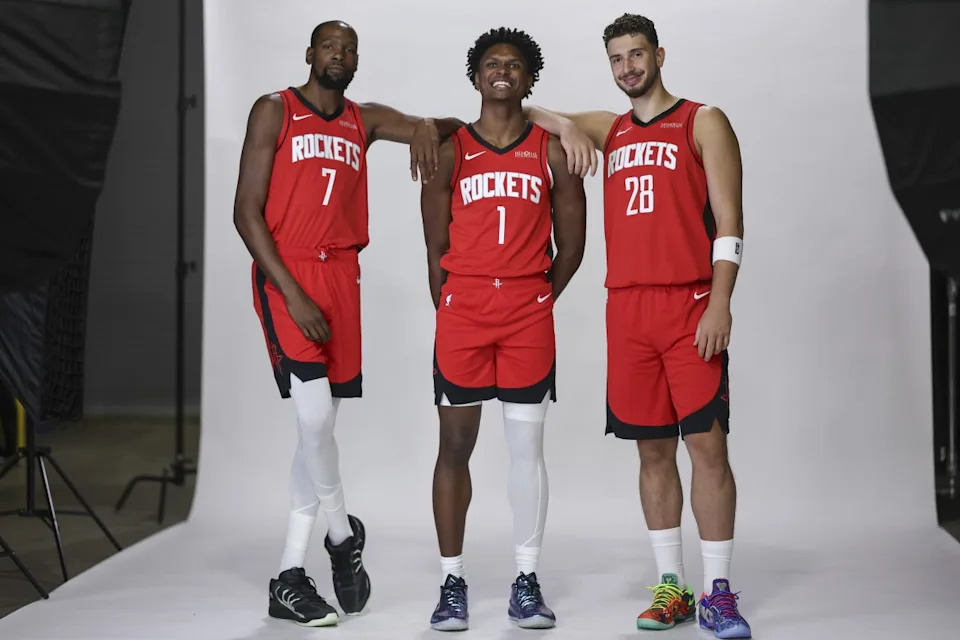 From left, Houston Rockets forward Kevin Durant, forward Amen Thompson and center Alperen Şengün pose for photos during media day at Toyota Center on Sept. 29, 2025.Troy Taormina-Imagn Images