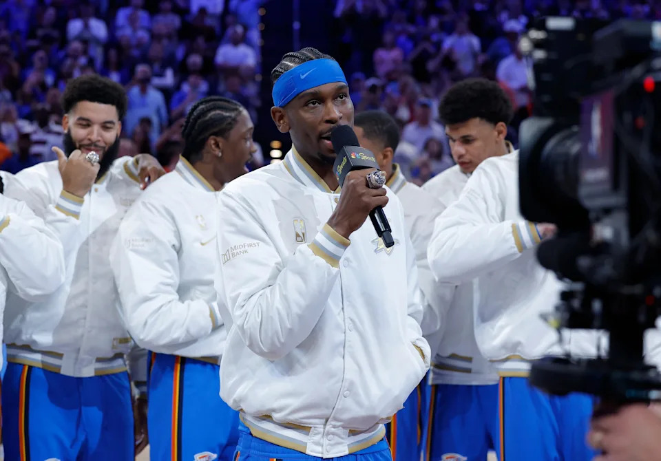 Oct 21, 2025; Oklahoma City, Oklahoma, USA; Oklahoma City Thunder guard Shai Gilgeous-Alexander talks to fans during the championship ring ceremony before the start of their game against the Houston Rockets at Paycom Center. Mandatory Credit: Alonzo Adams-Imagn Images