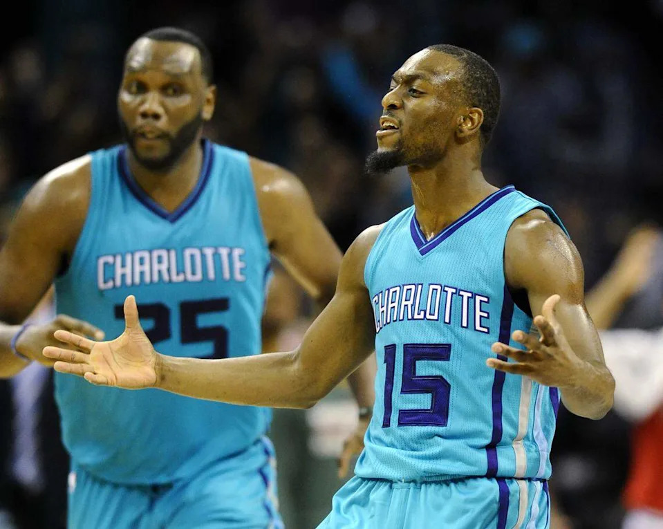 Oct. 29, 2014: Charlotte Hornets guard Kemba Walker (15) celebrates a basket against the Milwaukee Bucks at Time Warner Cable Arena as Al Jefferson (25) looks on. The Hornets came back from 24 points down to win the game, 108-106, in overtime.