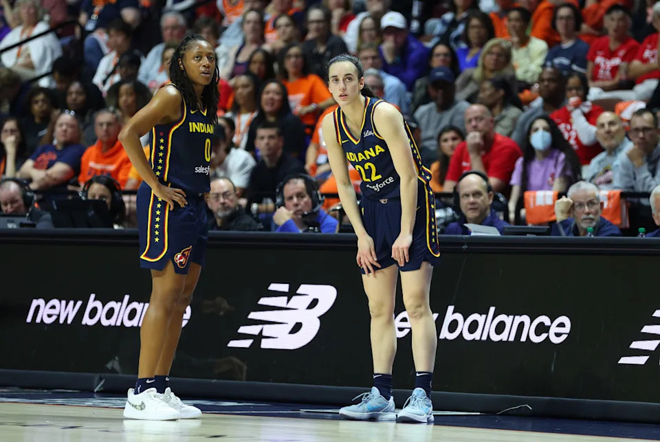 UNCASVILLE, CT - SEPTEMBER 22: Indiana Fever guard Kelsey Mitchell (0) speaks with Indiana Fever guard Caitlin Clark (22) as she waits to enter the game during the First Round and game 1 of the 2024 WNBA playoffs between Indiana Fever and Connecticut Sun on September 22, 2024, at Mohegan Sun Arena in Uncasville, CT. (Photo by M. Anthony Nesmith/Icon Sportswire via Getty Images)Icon Sportswire&sol;Getty Images