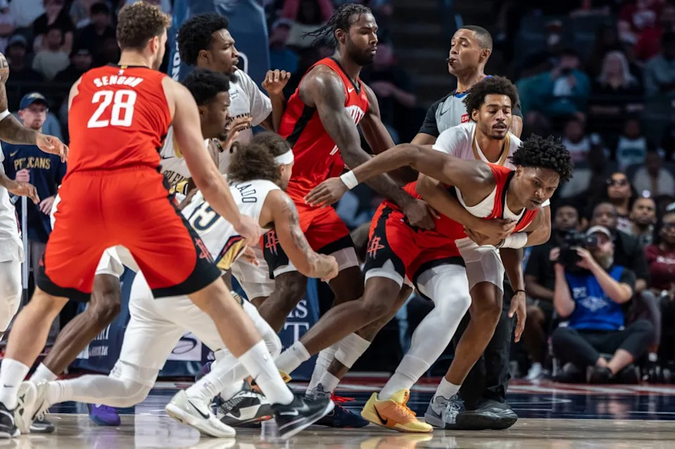 Pelicans guard Jose Alvarado (15) and Rockets guard-forward Amen Thompson (1) are pulled apart after a skirmish during an NBA preseason game at Legacy Arena at BJCC on Oct. 14, 2025. Vasha Hunt-Imagn Images