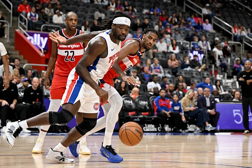 Oct 16, 2025; Detroit, Michigan, USA; Detroit Pistons forward/center Isaiah Stewart (28) battles for the ball with Washington Wizards center Alex Sarr (20) in the first quarter at Little Caesars Arena.