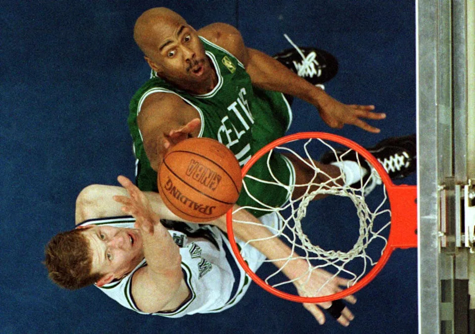 DALLAS, TX - MARCH 5: Alton Lister of the Boston Celtics (R) scores two points with a tip-in over Shawn Bradley of the Dallas Mavericks (L) during first half action at Reunion Arena in Dallas, Texas 13 March. (Photo credit should read PAUL K. BUCK/AFP via Getty Images)