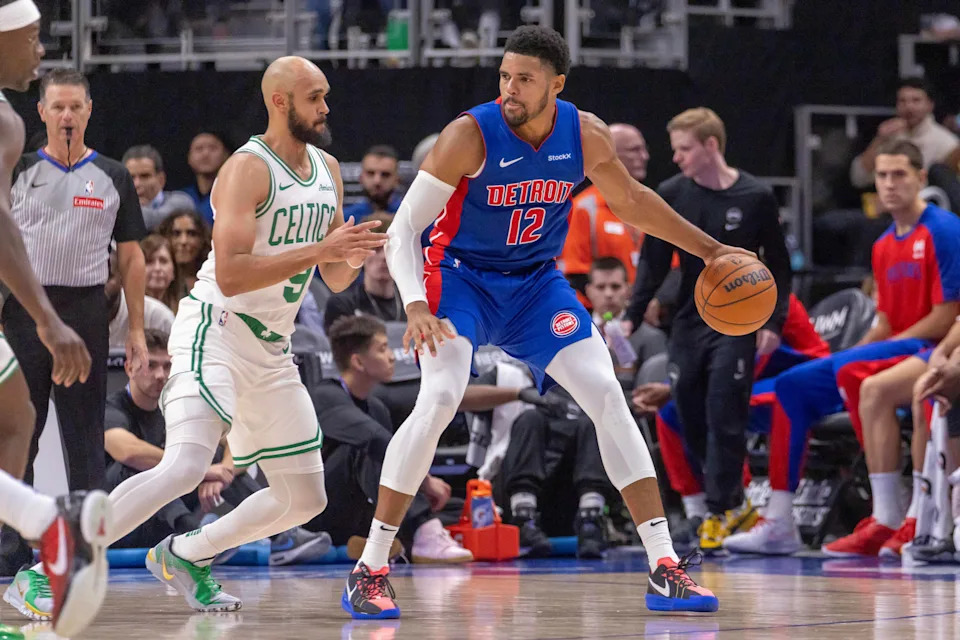 Oct 26, 2024; Detroit, Michigan, USA; Boston Celtics guard Derrick White (9) defends against Detroit Pistons forward Tobias Harris (12) during the in the first half at Little Caesars Arena. Mandatory Credit: David Reginek-Imagn Images