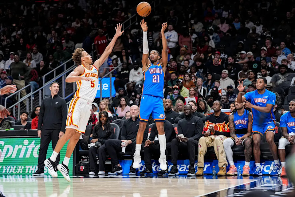 Oct 25, 2025; Atlanta, Georgia, USA; Oklahoma City Thunder guard Aaron Wiggins (21) shoots over Atlanta Hawks guard Dyson Daniels (5) during the second half at State Farm Arena. Mandatory Credit: Dale Zanine-Imagn Images