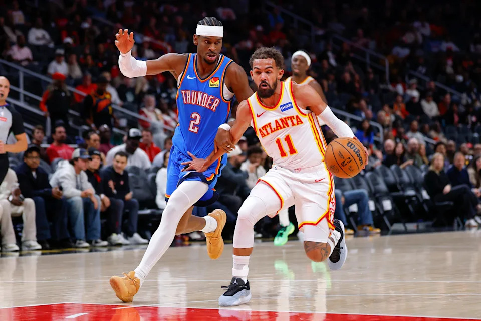 ATLANTA, GEORGIA - OCTOBER 25: Trae Young #11 of the Atlanta Hawks drives against Shai Gilgeous-Alexander #2 of the Oklahoma City Thunder during the first quarter at State Farm Arena on October 25, 2025 in Atlanta, Georgia. NOTE TO USER: User expressly acknowledges and agrees that, by downloading and or using this photograph, User is consenting to the terms and conditions of the Getty Images License Agreement. (Photo by Todd Kirkland/Getty Images)