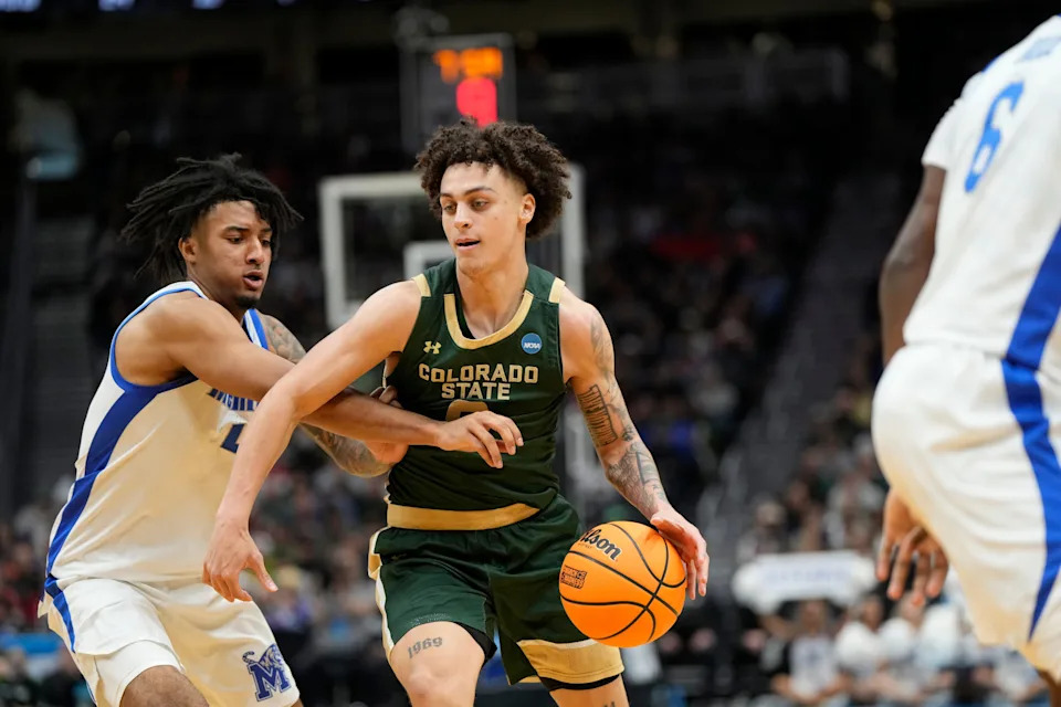 Mar 21, 2025; Seattle, WA, USA; Colorado State Rams guard Kyan Evans (0) drives the ball past Memphis Tigers guard PJ Haggerty (4) during the second half at Climate Pledge Arena. Mandatory Credit: Stephen Brashear-Imagn Images