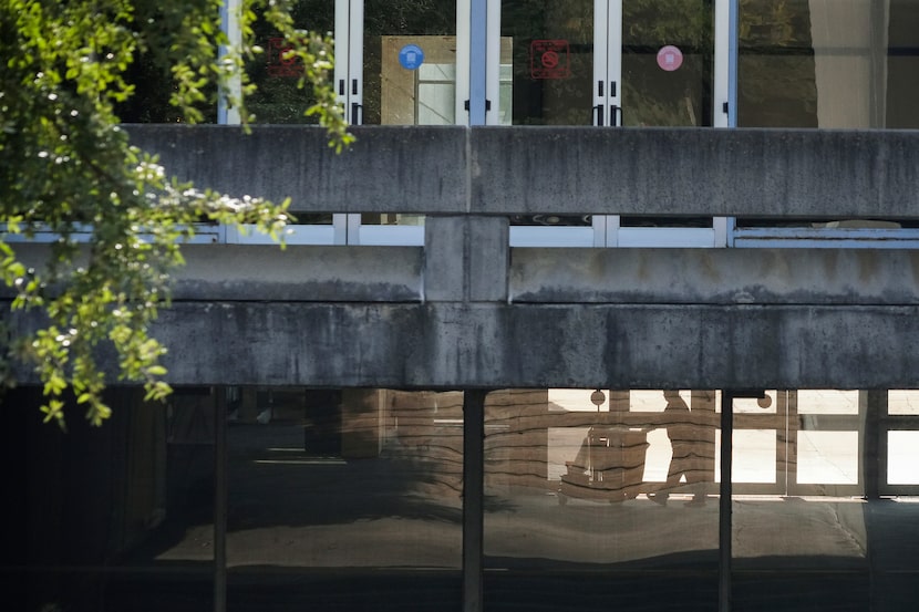 A worker is seen through the windows of the Kay Bailey Hutchison Convention Center on...