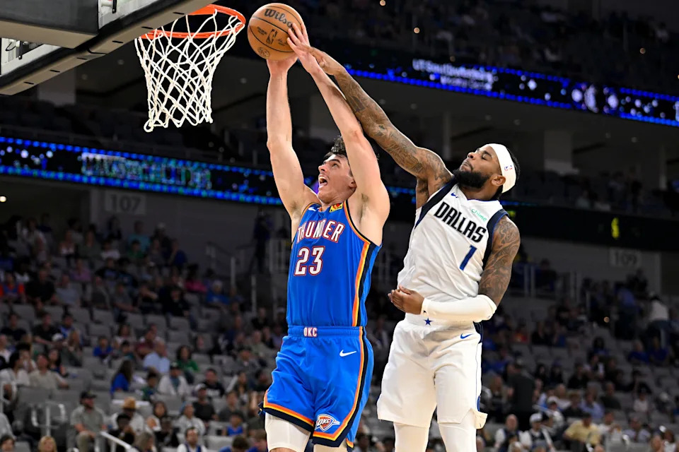 Oct 6, 2025; Fort Worth, Texas, USA; Oklahoma City Thunder guard Brooks Barnhizer (23) is fouled by Dallas Mavericks guard Jaden Hardy (1) during the second half at Dickie's Arena. Mandatory Credit: Jerome Miron-Imagn Images