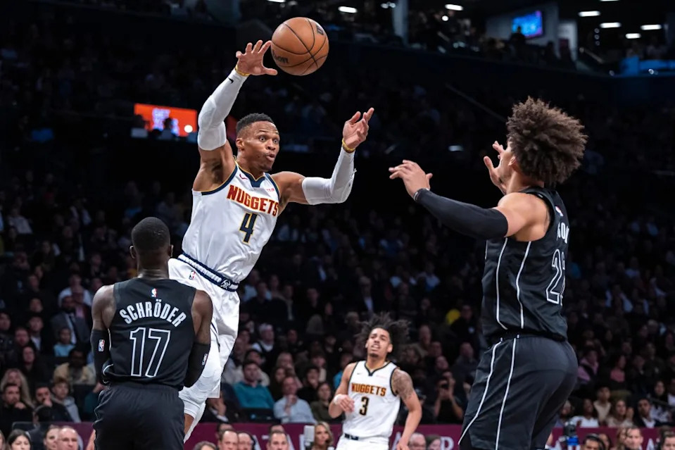 Denver Nuggets guard Russell Westbrook passes around Brooklyn Nets guard Dennis Schroder and forward Jalen Wilson on Oct. 29, 2024. Corey Sipkin for the NY POST