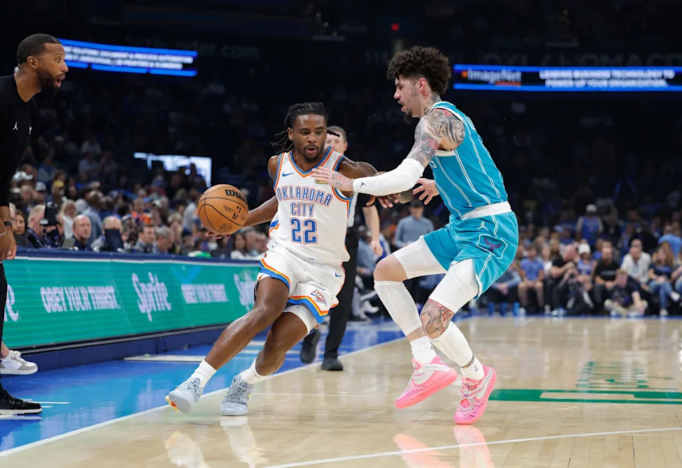 Oct 9, 2025; Oklahoma City, Oklahoma, USA; Oklahoma City Thunder guard Cason Wallace (22) drives around Charlotte Hornets guard Lamelo Ball (1) during the second quarter of a game between the Charlotte Hornets and the Oklahoma City Thunder at Paycom Center. Mandatory Credit: Alonzo Adams-Imagn Images