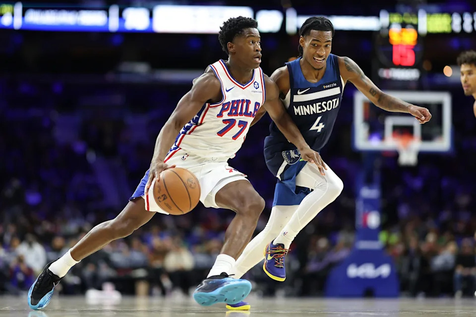 Oct 17, 2025; Philadelphia, Pennsylvania, USA; Philadelphia 76ers guard Vj Edgecombe (77) dribbles past Minnesota Timberwolves guard Rob Dillingham (4) during the third quarter at Xfinity Mobile Arena.