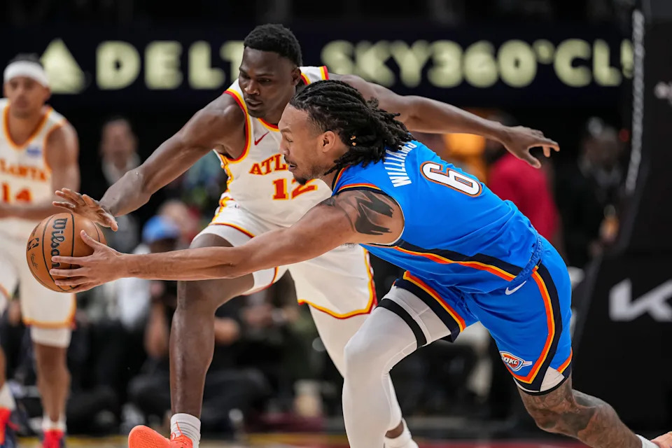 Oct 25, 2025; Atlanta, Georgia, USA; Atlanta Hawks center N'Faly Dante (12) and Oklahoma City Thunder forward Jaylin Williams (6) battle to control a loose ball during the first half at State Farm Arena. Mandatory Credit: Dale Zanine-Imagn Images