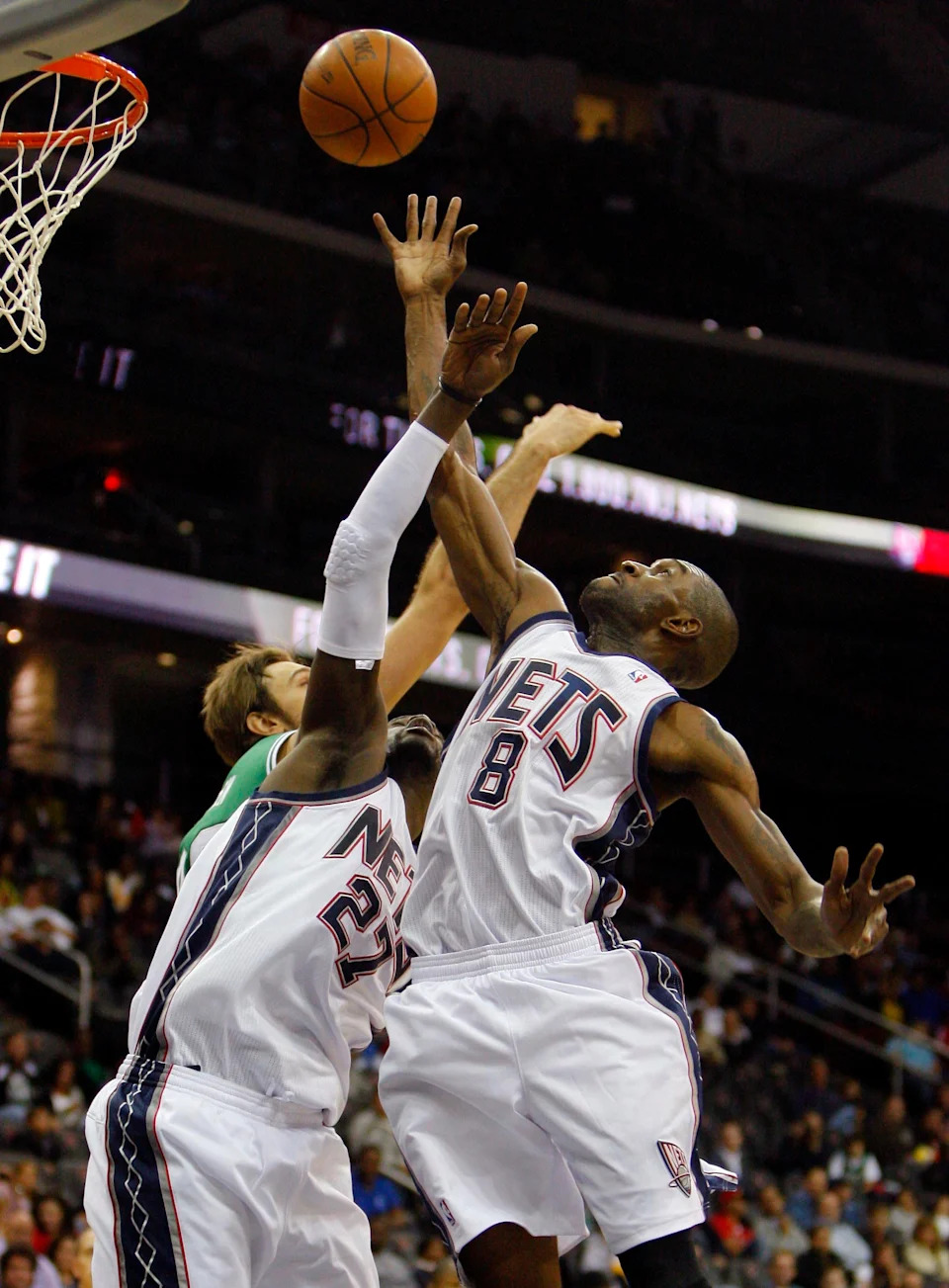 Oct 7, 2010; Newark, NJ, USA; New Jersey Nets center Johan Petro (27) and power forward Joe Smith (8) battle for loose ball against the Boston Celtics at the Prudential Center. Boston Celtics won 96-92. Mandatory Credit: Jim O'Connor-USA TODAY Sports