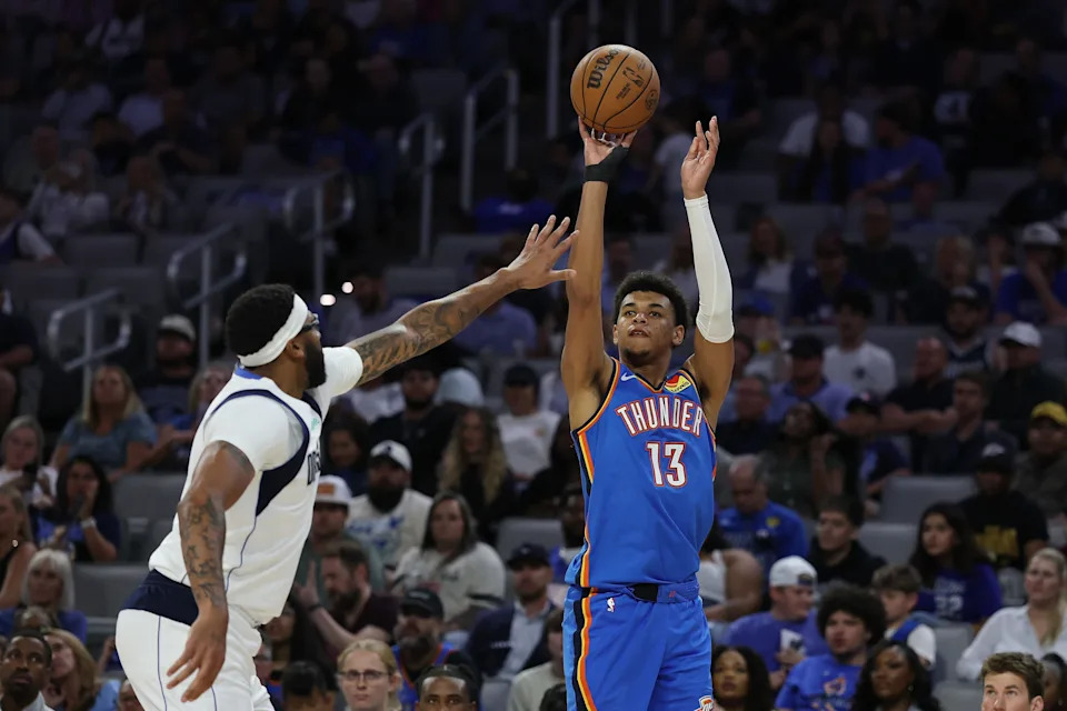 FORT WORTH, TEXAS - OCTOBER 06: Ousmane Dieng #13 of the Oklahoma City Thunder is defended by Anthony Davis #3 of the Dallas Mavericks during the first half of a preseason game at Dickies Arena on October 06, 2025 in Fort Worth, Texas. NOTE TO USER: User expressly acknowledges and agrees that, by downloading and or using this photograph, User is consenting to the terms and conditions of the Getty Images License Agreement. (Photo by Stacy Revere/Getty Images)
