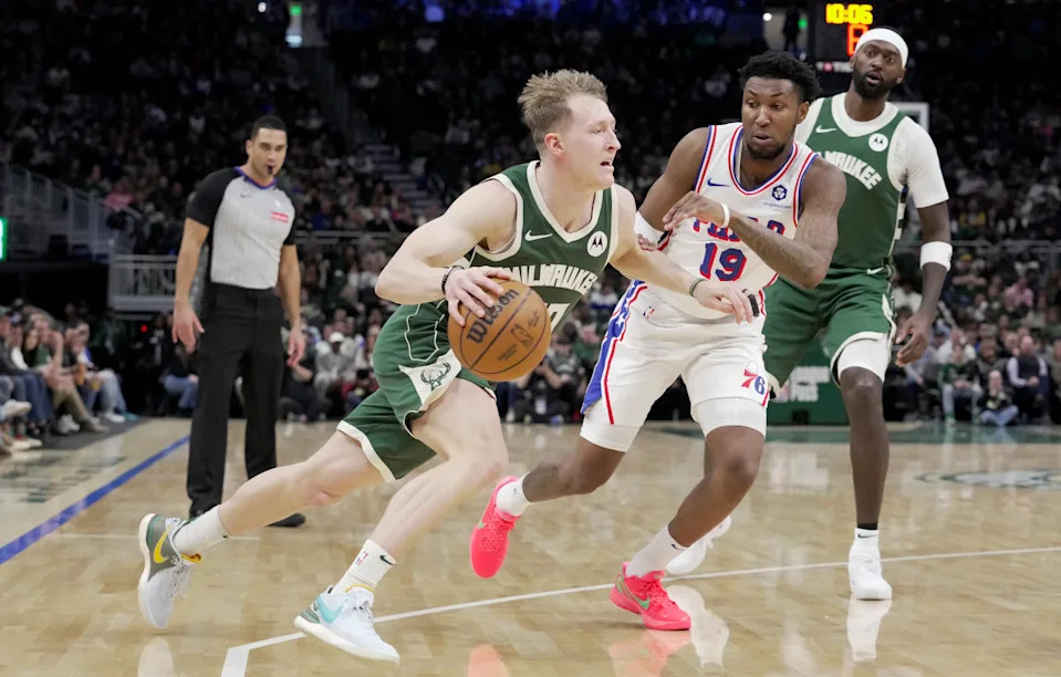 Milwaukee Bucks guard AJ Green (20) turns the corner on Philadelphia 76ers forward Justin Edwards (19) during the first half of their game Sunday, February 9, 2025 at Fiserv Forum in Milwaukee, Wisconsin.