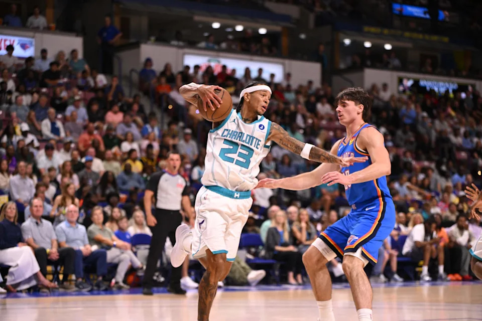 Oct 5, 2025; North Charleston, South Carolina, USA; Charlotte Hornets guard Tre Mann (23) grabs and guards the rebound against the Oklahoma City Thunder in the first quarter at North Charleston Coliseum. Mandatory Credit: Arthur Ellis-Imagn Images