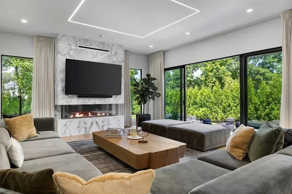 Living space with a fireplace in a luxury home in Massachusetts that belongs to Jrue Holiday