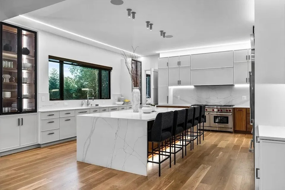 Kitchen with a large island and seating in a luxury home in Massachusetts that belongs to Jrue Holiday