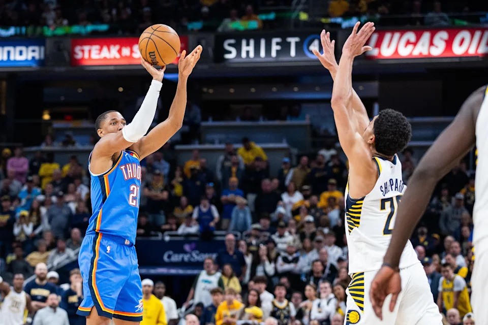 Oct 23, 2025; Indianapolis, Indiana, USA; Oklahoma City Thunder guard Aaron Wiggins (21) shoots the ball while Indiana Pacers guard Ben Sheppard (26) defends in the second half at Gainbridge Fieldhouse. Mandatory Credit: Trevor Ruszkowski-Imagn Images