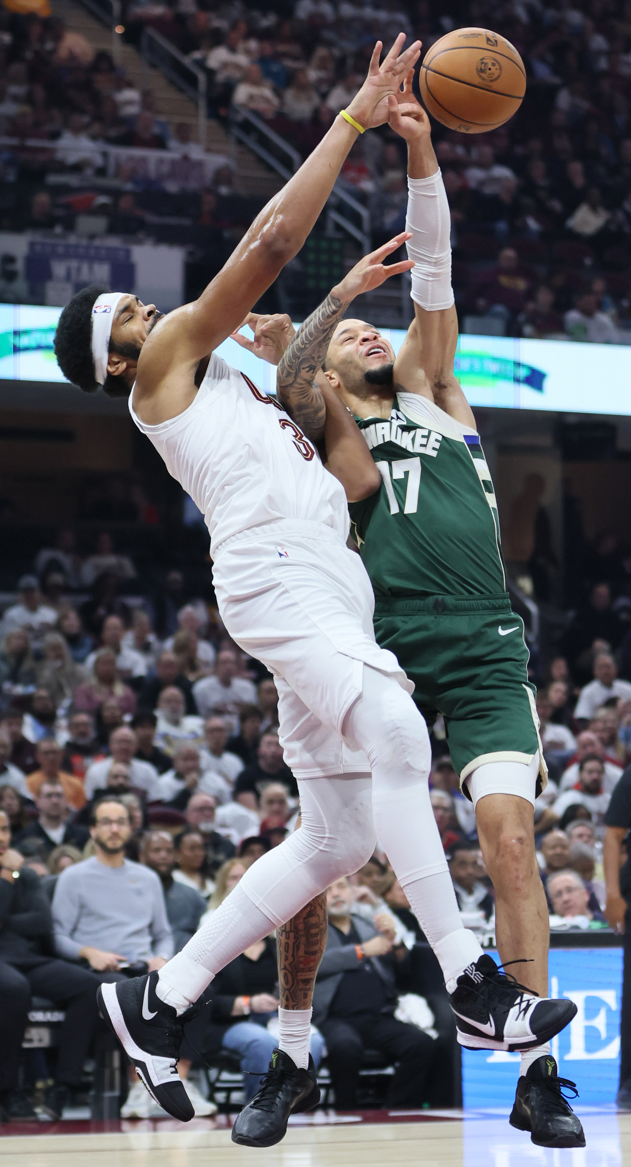 Milwaukee Bucks guard Amir Coffey (R) deflects a pass intended for Cleveland Cavaliers center Jarrett Allen in the first half at Rocket Arena. 