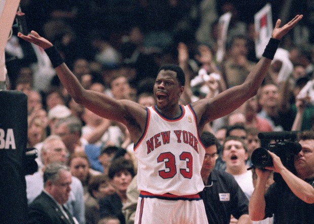 FILE - New York Knicks' Patrick Ewing encourages fans to cheer in the final seconds of their playoff game against the Charlotte Hornets in New York, in this Saturday, April 26, 1997, file photo. The Knicks won 100-93. Patrick Ewing and Georgetown are back in the NCAA Tournament. The 7-footer who helped the Hoyas win one national championship and reach two other finals in the 1980s is now coaching at his alma mater. Georgetown is a No. 12 seed and will play No. 5 Colorado in the East Region on Saturday. (AP Photo/Adam Nadel, File)