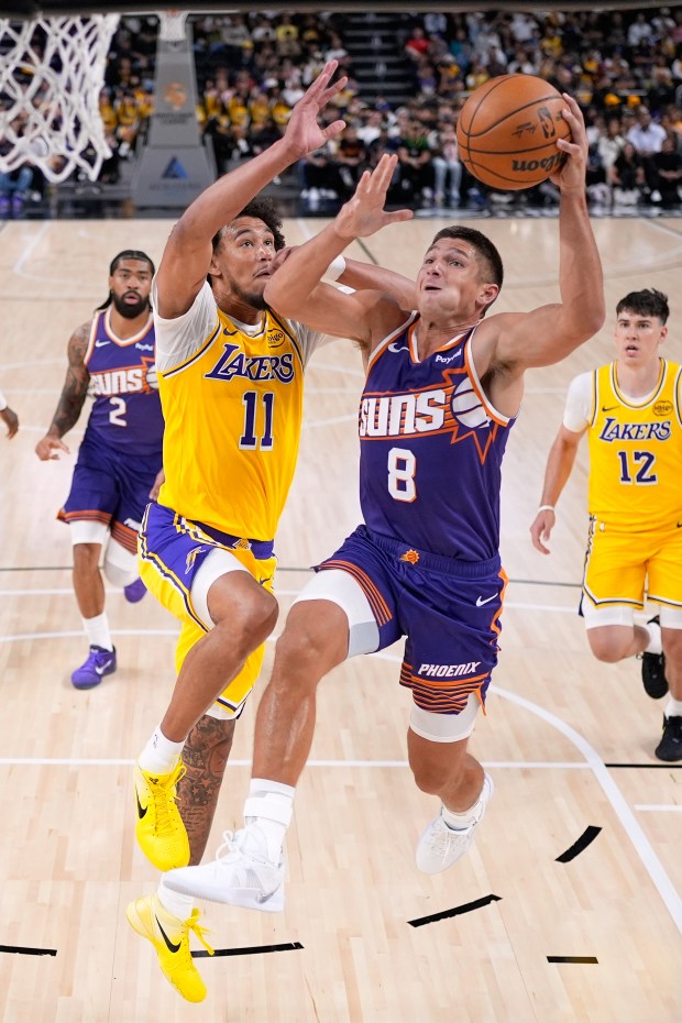 Phoenix Suns guard Grayson Allen, right, shoots as Lakers center...