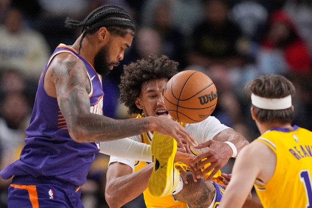 Phoenix Suns center Nick Richards, left, and Lakers center Jaxson...