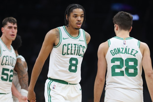 Boston Celtics' Josh Minott (8), Hugo González (28) and Luka Garza (52) on the court during the second half of a preseason NBA basketball game against the Cleveland Cavaliers, Sunday, Oct. 12, 2025, in Boston. (AP Photo/Michael Dwyer)