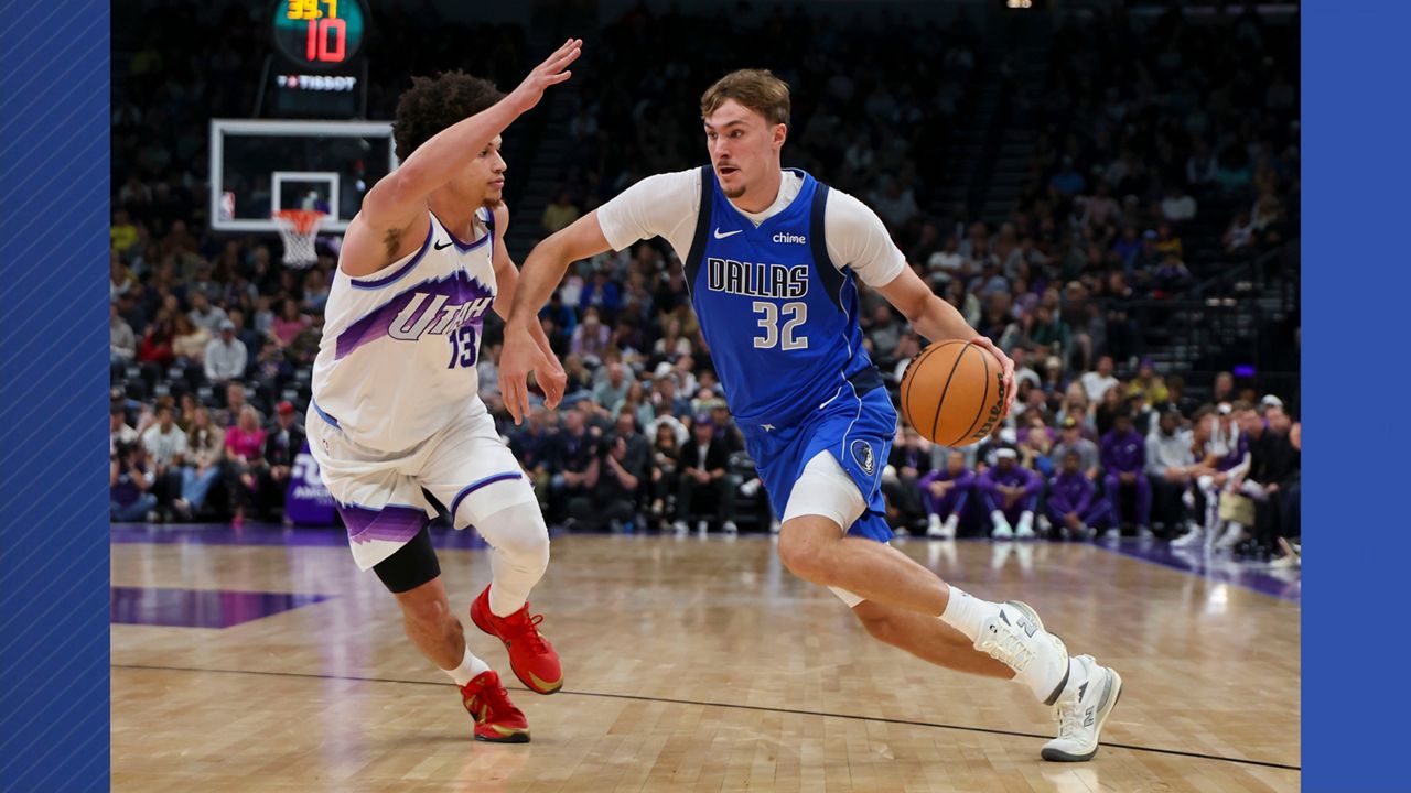 Dallas Mavericks forward Cooper Flagg (32) drives against Utah Jazz guard Walter Clayton Jr. (13) during the first half of a preseason NBA basketball game Monday, Oct. 13, 2025, in Salt Lake City. (AP Photo/Rob Gray)