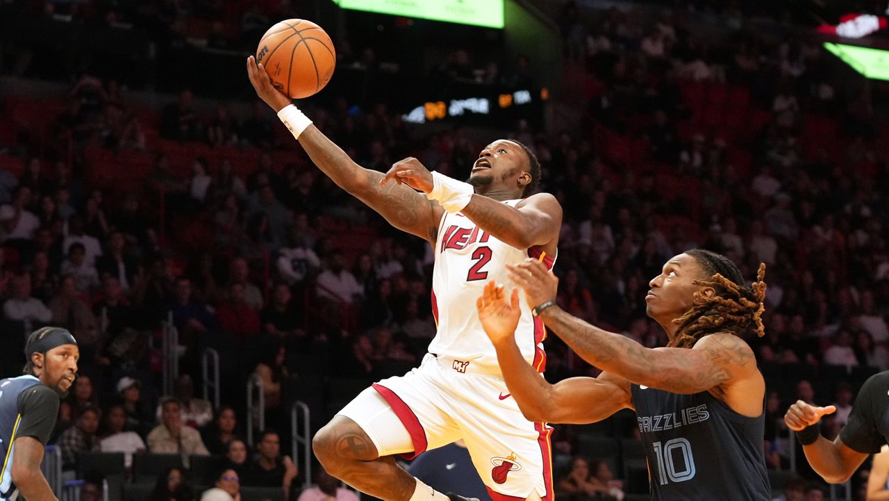 Miami Heat guard Terry Rozier (2) drives to the basket as Memphis Grizzlies guard Javon Small (10) defends during the second half of an NBA preseason basketball game Friday, Oct. 17, 2025, in Miami.